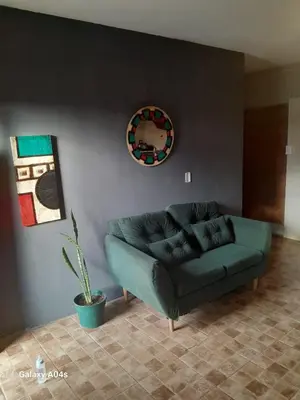 a living room with a green couch and a mirror at Mifauna in Villa del Dique