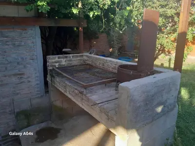 a brick oven with a grill in a yard at Mifauna in Villa del Dique