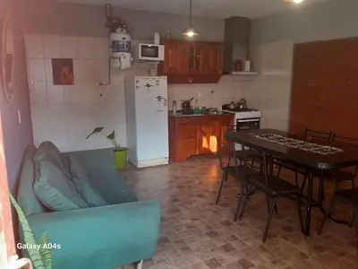 a kitchen with a couch and a table in a kitchen at Mifauna in Villa del Dique