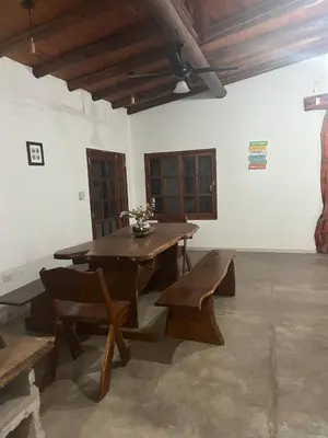 a wooden table and benches in a room at Casona Las Calles in Las Rabonas