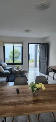 a living room with a wooden table and chairs at Alojamiento en las sierras 2 dormitorios in Villa General Belgrano