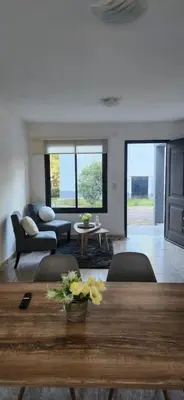 a living room with a table and a couch at Alojamiento en las sierras 2 dormitorios in Villa General Belgrano