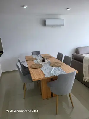 a wooden table in a room with chairs and a couch at plaza Colonn in Cordoba