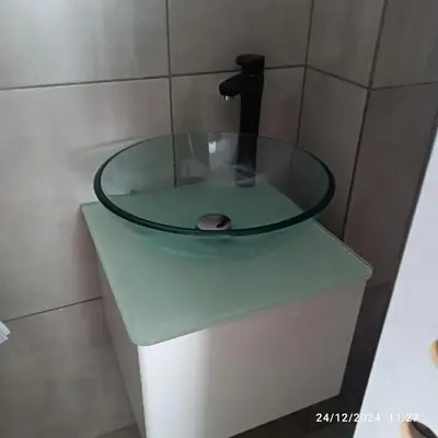a glass sink in a bathroom with a faucet at plaza Colonn in Cordoba