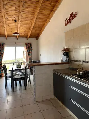 a kitchen with a table and a dining room at Alta vista casa de campo Tanti in Tanti