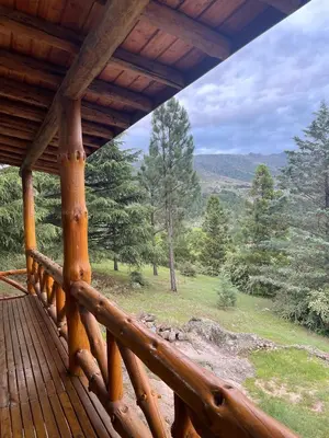a porch of a cabin with a view of the mountains at Refugio Alpino in La Cumbrecita