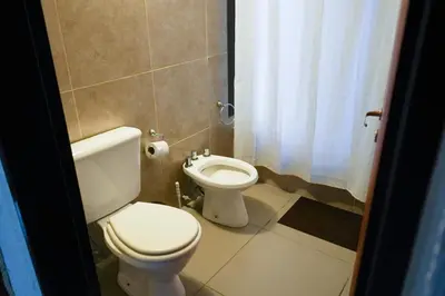 a bathroom with a toilet and a bidet at Refugio Alpino in La Cumbrecita