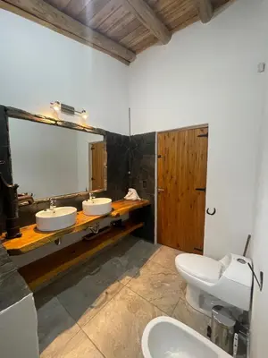 a bathroom with two sinks and a large mirror at Refugio Alpino in La Cumbrecita