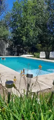 a swimming pool with blue water in a yard at Cabañas Vista Ensueño in La Estancia