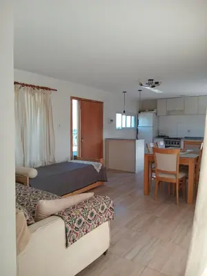 a living room with a bed and a dining room at Cabañas Vista Ensueño in La Estancia
