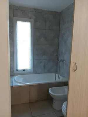 a bathroom with a tub and a toilet and a window at Cabañas Vista Ensueño in La Estancia