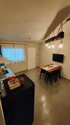 a living room with a table and a kitchen at Apartamento Urbano Bialet Masse in Bialet Massé