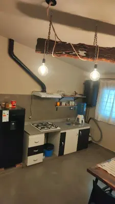 a kitchen with a stove and some lights at Apartamento Urbano Bialet Masse in Bialet Massé