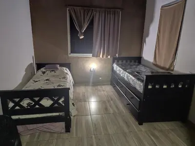 a bedroom with two beds and a window at La soñada in Villa Santa Cruz del Lago
