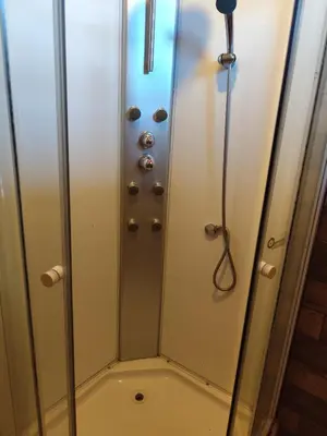 a shower with a glass door and a shower at La soñada in Villa Santa Cruz del Lago