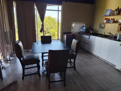 a kitchen with a table and chairs in a kitchen at La soñada in Villa Santa Cruz del Lago