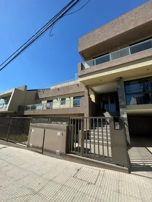 a building with a gate in front of it at Departamento Tatin in Villa Carlos Paz