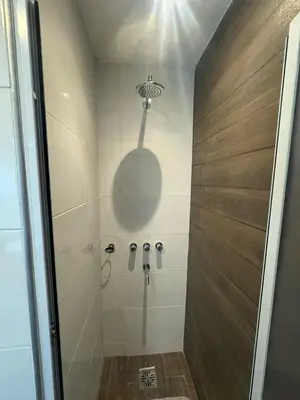 a bathroom with a shower with a glass door at Departamento Tatin in Villa Carlos Paz