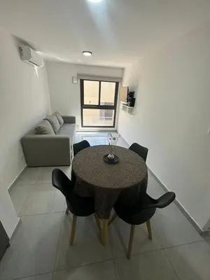 a living room with a table and chairs and a couch at Departamento Tatin in Villa Carlos Paz