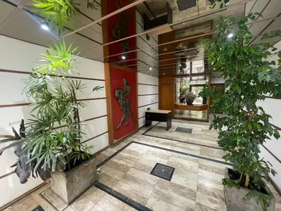 a lobby with potted plants and a red door at Prueba 2 in Cordoba