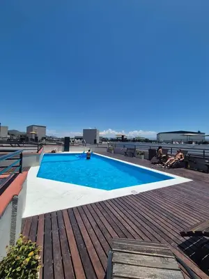 a swimming pool on the roof of a building at Departamento Claudio in Villa Carlos Paz