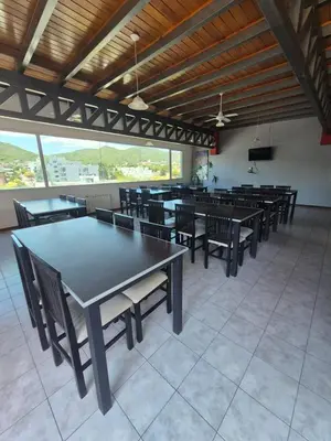 a large dining room with tables and chairs at Departamento Claudio in Villa Carlos Paz