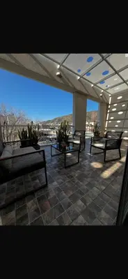 a patio with benches and a view of the ocean at Departamento céntrico Terraza propia con vista a las montañas in Villa Carlos Paz
