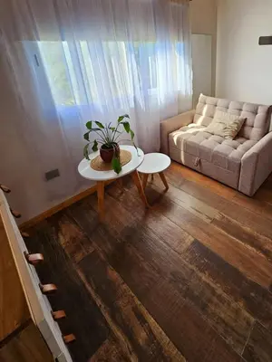 a living room with a couch and a table at Complejo Falda del Sauce in Villa General Belgrano