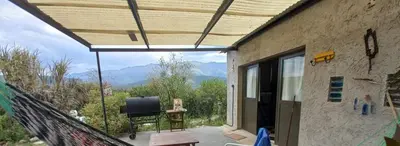 a room with a balcony with a view of the mountains at Frente a la sierra in Quebrada de los Pozos