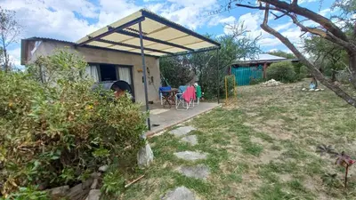 a house with a tent and a wheelchair in a yard at Frente a la sierra in Quebrada de los Pozos