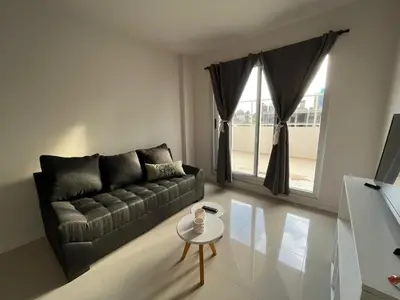 a living room with a couch and a table at Departamento opera torre 3 in Villa Carlos Paz
