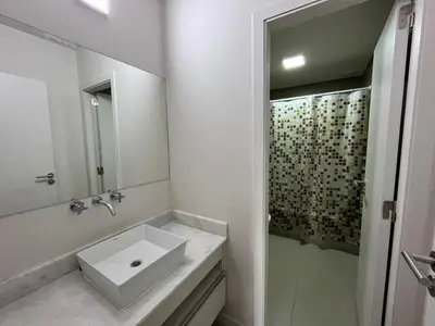 a white bathroom with a sink and a shower at Departamento opera torre 3 in Villa Carlos Paz