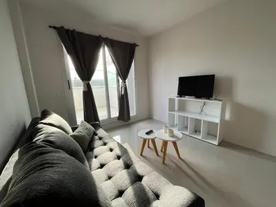 a living room with a couch and a tv at Departamento opera torre 3 in Villa Carlos Paz