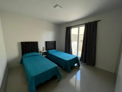 a room with two beds and a window at Departamento opera torre 3 in Villa Carlos Paz