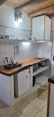 a kitchen with a wooden counter top in a kitchen at Cabañas Cerro Colonial in Trapiche