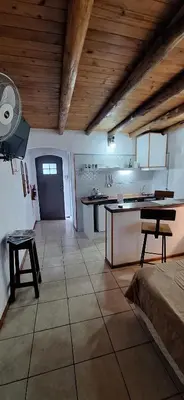 a large room with a kitchen with a fan at Cabañas Cerro Colonial in Trapiche