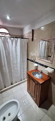 a bathroom with a sink and a toilet and a mirror at Cabañas Cerro Colonial in Trapiche