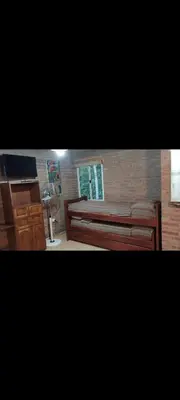 a bedroom with a large bed and a window at Cabañas Rio de Oro in Mina Clavero