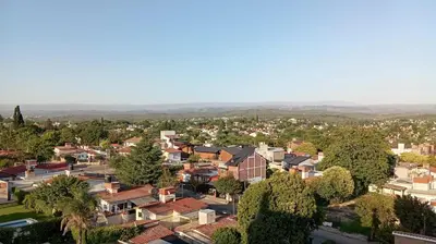 an aerial view of a town with houses at Dept with pool and view in Villa Carlos Paz