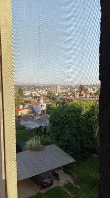 a view of a city from a window at Dept with pool and view in Villa Carlos Paz