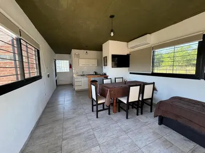 a kitchen and dining room with a table and chairs at Dos Eucaliptus in Villa Rumipal
