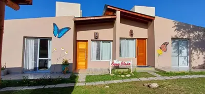 a house with butterflies painted on the side of it at Cabañas Casa Clara in Santa Rosa de Calamuchita