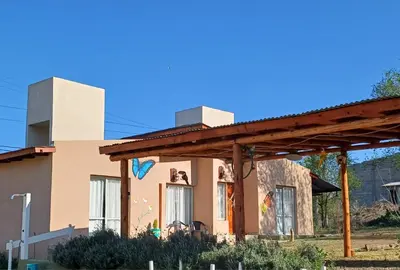 a house with a painting on the side of it at Cabañas Casa Clara in Santa Rosa de Calamuchita