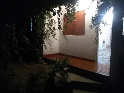 a house with a wooden porch and a wooden door at Casa jazmines in Villa Santa Cruz del Lago