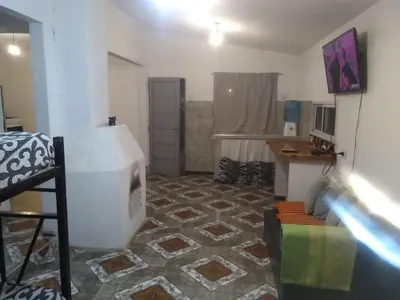 a room with a living room with a fireplace in it at Casa jazmines in Villa Santa Cruz del Lago