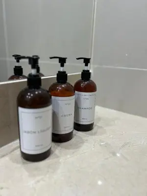 three bottles of soap sitting on a counter at Apart France - Charmant Suites in Río Cuarto