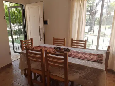 a dining room with a table and chairs and a window at Casa Emilia Tanti in Tanti