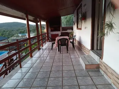 a balcony of a house with a table and chairs at El Descanso cabaña in Cavalango