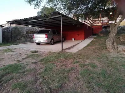 a car parked under a canopy in a parking lot at El Descanso cabaña in Cavalango