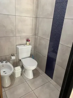 a bathroom with a white toilet and a sink at El despertar Hospedaje in San Francisco del Monte de Oro